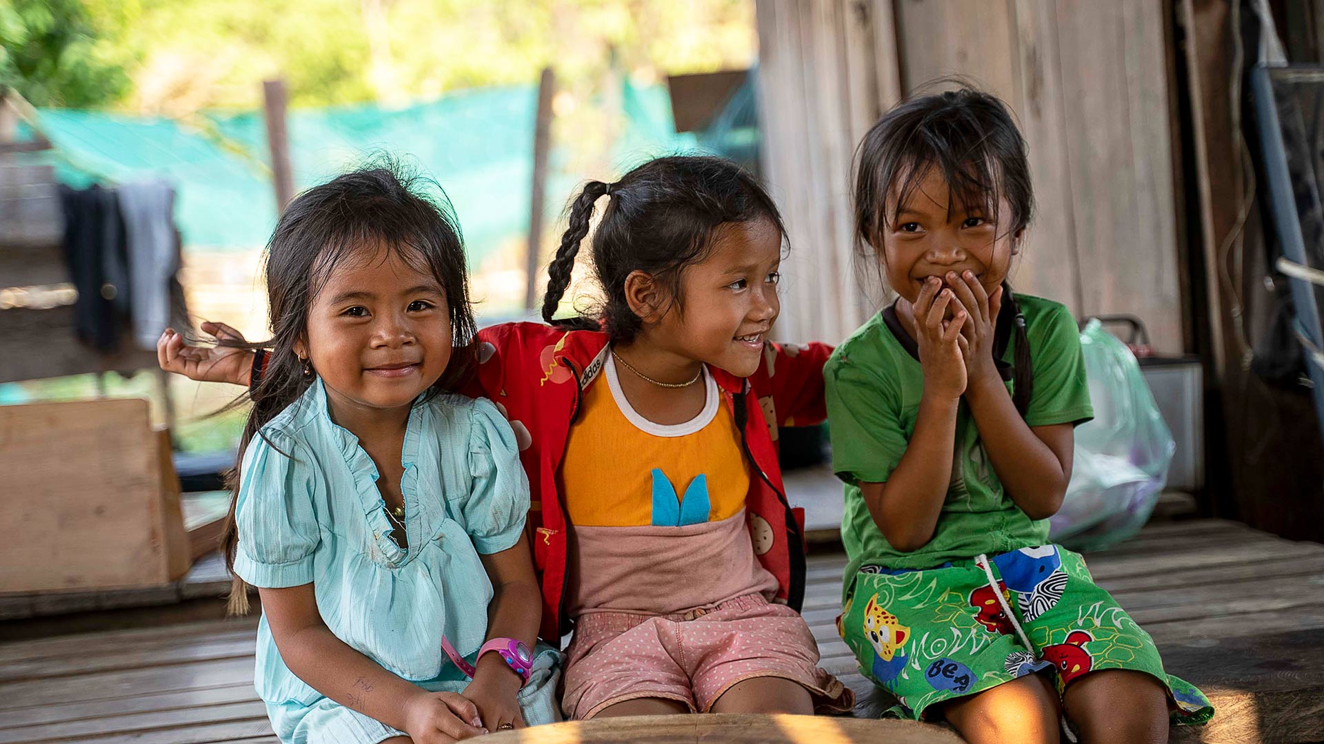 7-year-old Pheap (far right) at home with her two younger sisters