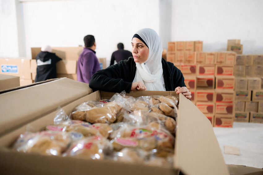 Plan Egypt staff prepare relief aid for transportation to Gaza  