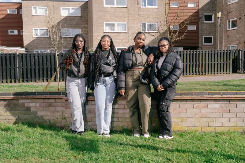 four girls look at the camera