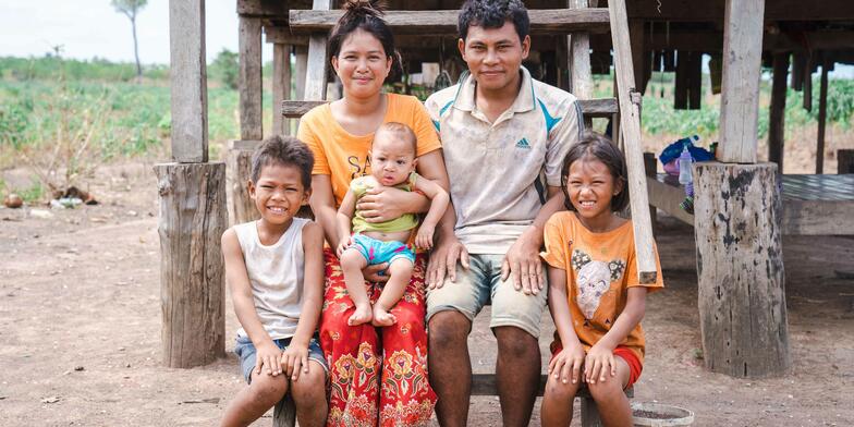 Muta, 11, with her parents and siblings in front of their house 