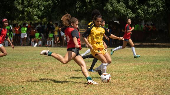 Girls playing in a football tournament as part of a Plan International programme in Brazil