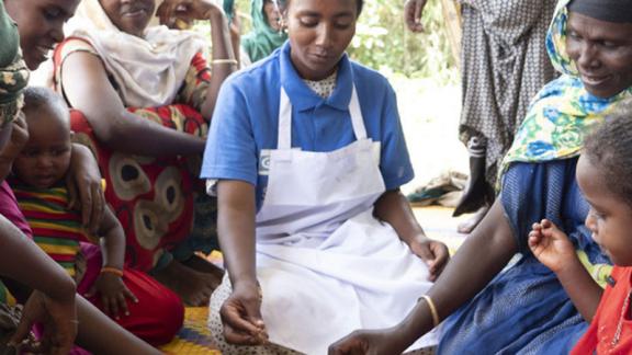 Addis eats with mums and children at the health station