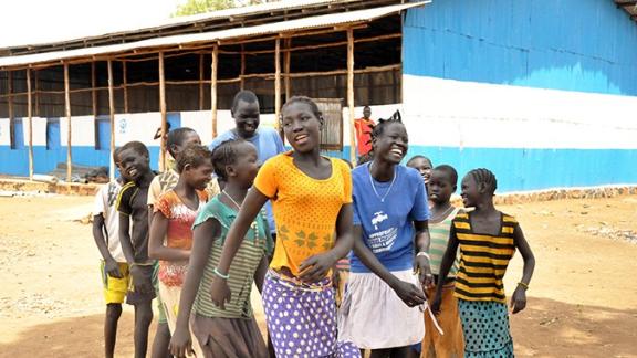 Children play in front of a primary school constructed by Plan International in Ethiopia, which is hosting many of the 1.5 million refugees who have fled conflict in neighbouring South Sudan