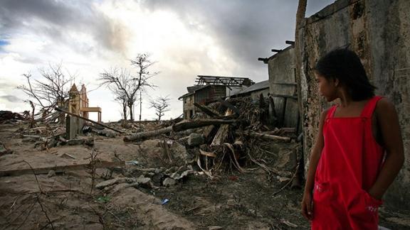 A girl looks at the devastation caused by Typhoon Haiyan in the Philippines