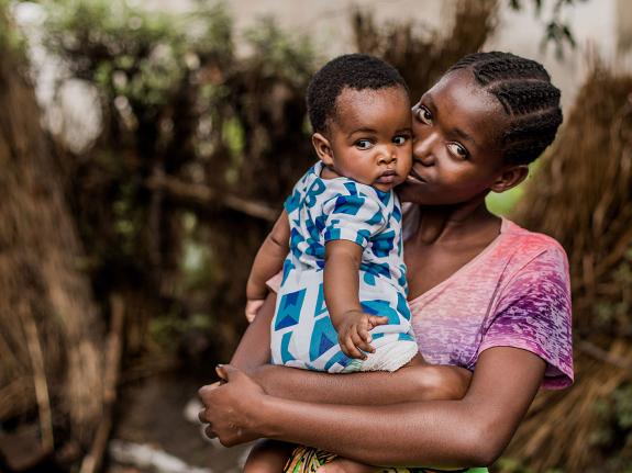 Melissa, 18, holding her baby in Zambia.