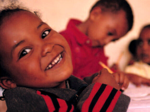 A young child smiling at the camera