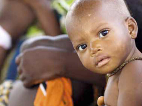 A young boy looks at the camera