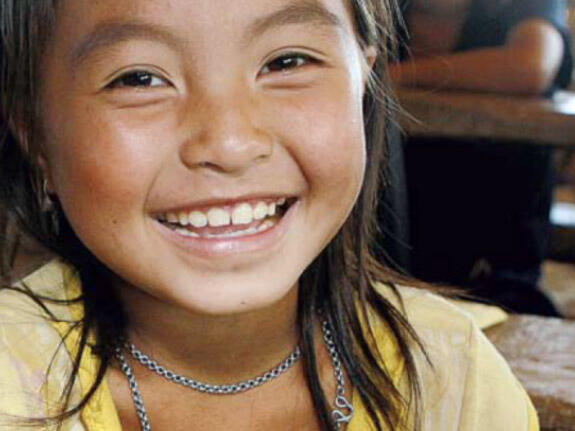 A young girl smiling at the camera