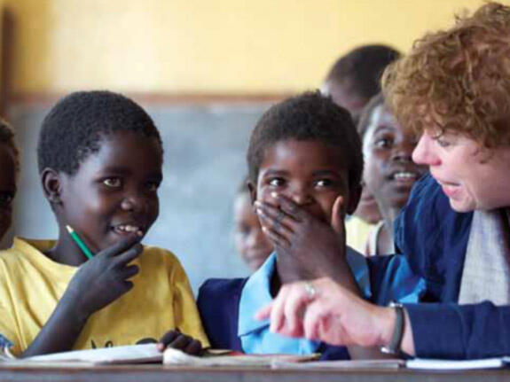 A teacher and their pupils in a classroom