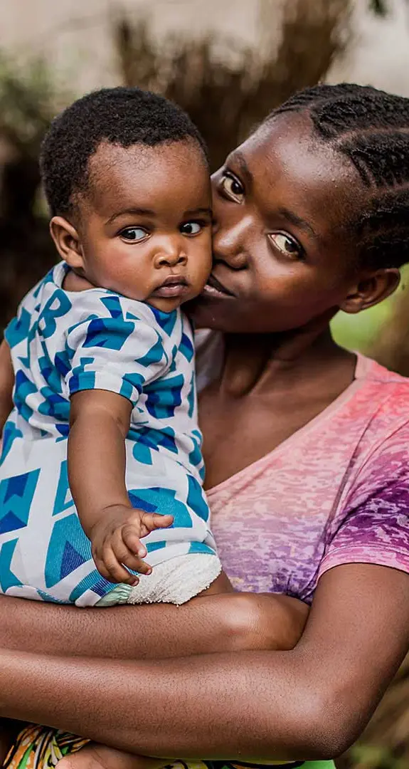 Melissa, 18, holding her baby in Zambia.