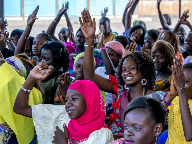 women with raised hands