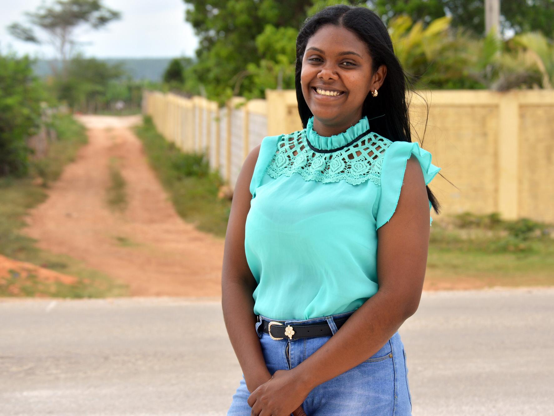 Jeidy, 24, a teacher in the Dominican Republic standing in a street smiling at the camera