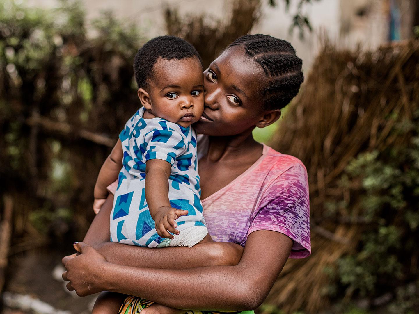 Melissa, 18, holding her baby in Zambia.