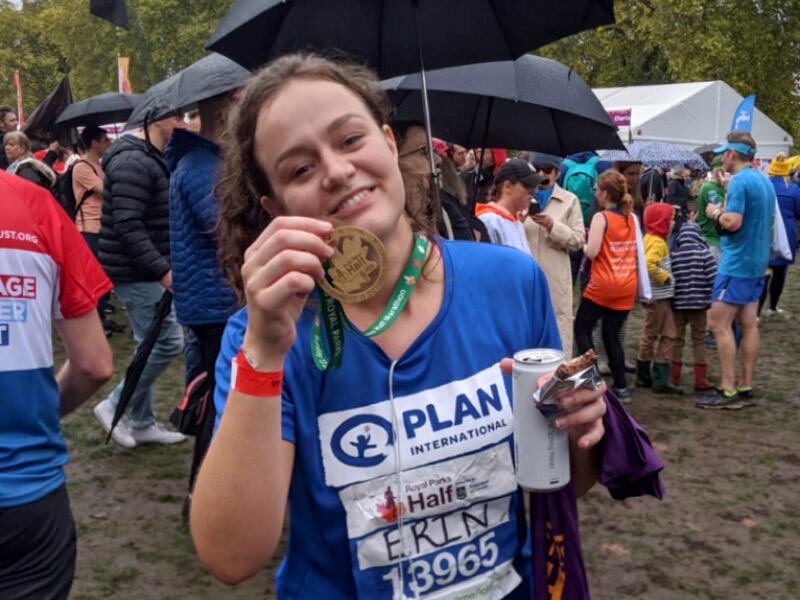 A female marathon runner holding up her medal